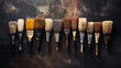 Assortment of Aged Paintbrushes with Various Bristles Lined Up on a Dark Textured Background