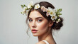 © Ольга Симонова - A young brunette woman with a hairstyle of spring flowers in her hair on a white solid background. Feminine beauty portrait, makeup, hairstyle, stylist, feminine energy
