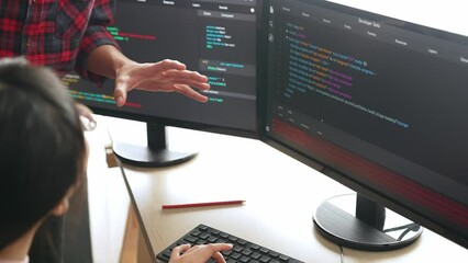 Slow motion back end or software developer manager supervising his team on new application program development on debugging and solving complex code algorithms on monitor. Burgeoning