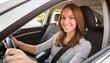 © Marko - young adult woman driving a car, smiling joyfully