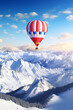 canvas print picture - Heißluftballon fliegt über schneebedeckten Bergen, Winterbanorama über einem Gebirge