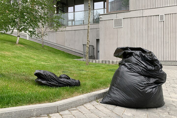 Black bags of garbage outside the new building.