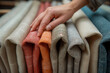 © Natali - catalogue with small modern fabric samples. Close-up of a hand touching the cloth