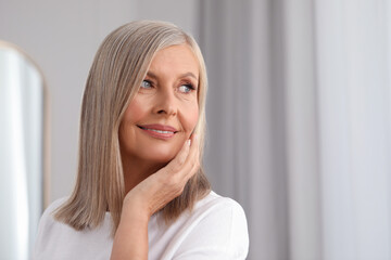 Canvas Print - Portrait of beautiful middle aged woman indoors. Space for text