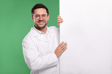 Canvas Print - Ophthalmologist with blank banner on green background, space for text