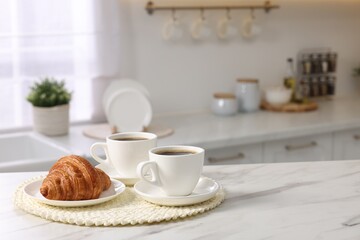 Sticker - Breakfast served in kitchen. Cups of coffee and fresh croissant on white marble table. Space for text