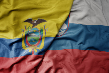 big waving national colorful flag of slovenia and national flag of ecuador .