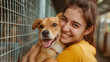 A happy female help adopt a dog from dog rescue shelter. A dog is happy.
