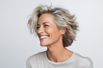 Wall Mural - Portrait of a beautiful smiling middle aged woman with blonde hair.