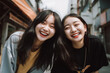 © Oliver Evans Studio - two young asian girls laughing out loud teenagers friends outdoors smiling happy city street lipstick casual jackets bright light complicity bond friendship enjoying cheerful upbeat youth joy joyful