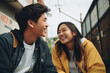 asian friends outdoors couple laughing happy young teenagers street of a city casual clothes jacket shirt girl boy smiling soft colors complicity bond love friendship friends enjoying cheerful 