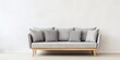 © Lasvu - Stylish Scandinavian sofa with gray upholstery, legs, and pillows on white background.