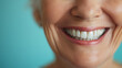 © Michael - elderly ethnic person, beautiful white smile on blue background, dental photo