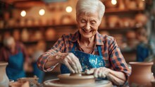 Craftsmanship In Older Age: Smiling Woman Enjoying Pottery Wheel In Studio