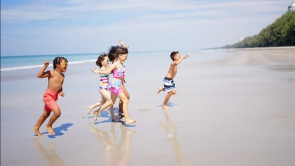 Wall Mural - Group of Children kid enjoy and fun outdoor lifestyle travel ocean on summer beach holiday vacation. Diversity child boy and girl friends running on the beach and playing sea water at tropical island.