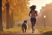 Woman Running With Dog In Park
