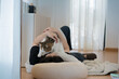 © tickcharoen04 - wellness and wellbeing concept with asian woman lie down and read book and play with her cat in livingroom