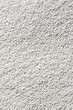 © SKfoto - Vertical image of a lot of white plastic polymer granules..