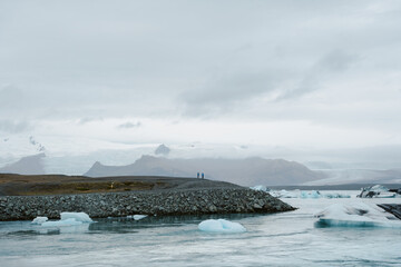 Wall Mural - Black sand hillside in rural Iceland overseeing glacial lake