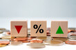 Interest rate finance and mortgage rates concept. Financial and banking, Interest rate, Deflation, Inflation, sale price and tax rise.  Wooden blocks with percentage sign and arrow up and arrow down.