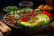 Healthy food in black bowl, with chickpeas, juicy pomegranate seeds and creamy avocado slices.