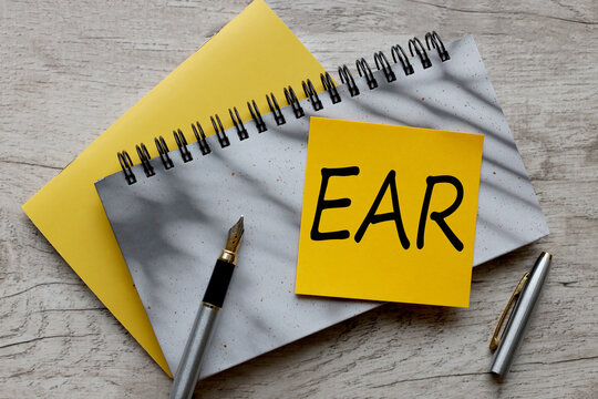EAR text on a yellow sticker on a gray notepad