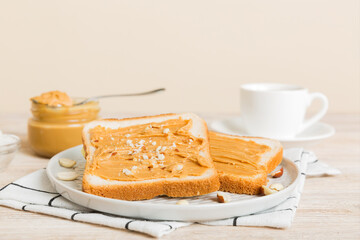 Canvas Print - Peanut butter sandwiches or toasts on light table background.Breakfast. Vegetarian food. American cuisine top view vith copy space