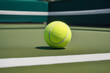 Bright green tennis ball on the tennis court with a blurred background, close up