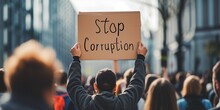 Protestors Hold Up A Sign Protesting Corruption