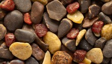 Background Of Little Dark Brown Red And Yellow Stones Close Up View