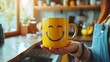 © Ilja - Happy morning concept with hands holding a coffee cup featuring a cheerful smiley face on the mug