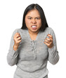 © Asier - Young chinese woman isolated upset screaming with tense hands.