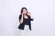 © Ajab - the charm of a beautiful Asian office woman in her 20s with a surprised expression while making a phone call on a cellphone gadget while pointing her hand up isolated on a white background