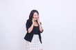 © Ajab - the charm of a beautiful Asian office woman in her 20s, laughing expression while making a phone call on a cell phone gadget while covering her mouth isolated on a white background