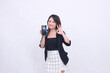 © Ajab - charm beautiful asian office girl 20s cheerful expression carrying cellphone gadget facing back while hand nice circular sign isolated white background