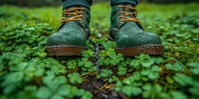 Leprechaun Feet In Green Boots On A Wet Forest Floor, Celebrating Nature And Outdoor Adventures.