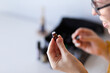 © Austockphoto - Young woman smelling bottle of essential oils