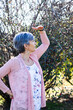 © Austockphoto - Woman in garden looking into the distance