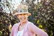 © Austockphoto - Happy senior woman with a big grin outside in the garden