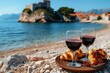 Indulge in a serene moment of relaxation as you sip on a glass of crisp wine and savor the buttery goodness of a croissant, all while gazing at the endless horizon of the sparkling ocean