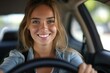 A stylish woman exudes joy and confidence as she poses behind the wheel of a car, her beaming smile and trendy outfit capturing the essence of outdoor adventure