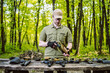 © johnalexandr - guy in the woods tests his weapons for shooting sports