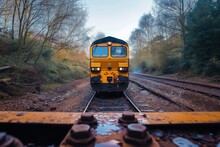 As The Yellow Locomotive Rolls Along The Railway Tracks Through The Lush Forest, The Sky Above And The Trees Below Become A Blur, Transporting Us To A Peaceful And Serene Outdoor Journey On This Land