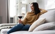 © opolja - Portrait of pretty, charming, attractive, stylish woman sitting on couch having raised glass with red wine in hand, examine, taste beverage.
