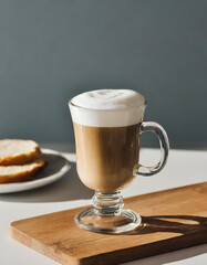 Wall Mural - Cappuccino or latte coffee in a glass cup on gray background