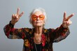 © Pinklife - A stylish elderly woman confidently poses in her fashionable sunglasses, exuding a sense of grace and elegance through her beaming smile and stylish eyewear