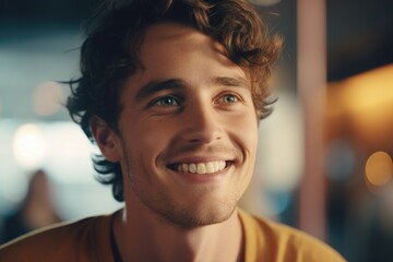 Poster - A man with curly hair smiling directly at the camera. Suitable for various uses