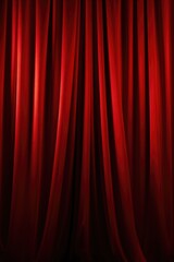 Poster - A vibrant red curtain hanging against a dark black background. Suitable for theater, stage, or interior design projects