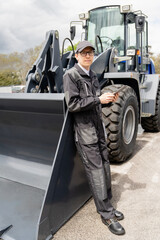 Sticker - Serviceman with digital tablet on a background of the tractor.