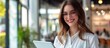 © Emin - Content woman manager with touch pad in modern office, young smart female secretary smiling on digital tablet